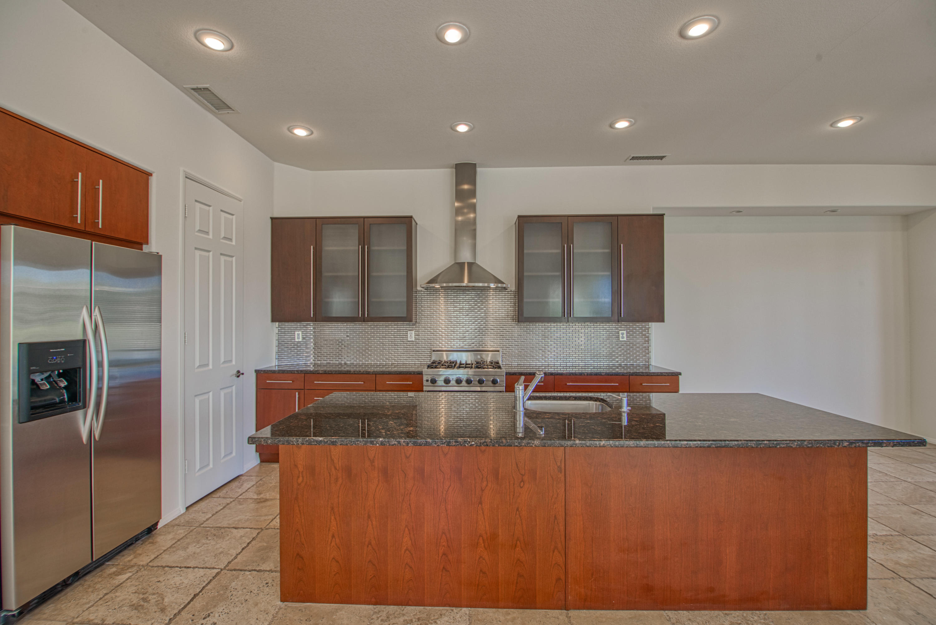 13 Wimbledon Circle Rancho Mirage, CA 92270 - Photo 55 of 62 a kitchen with stainless steel appliances granite countertop a sink and a refrigerator