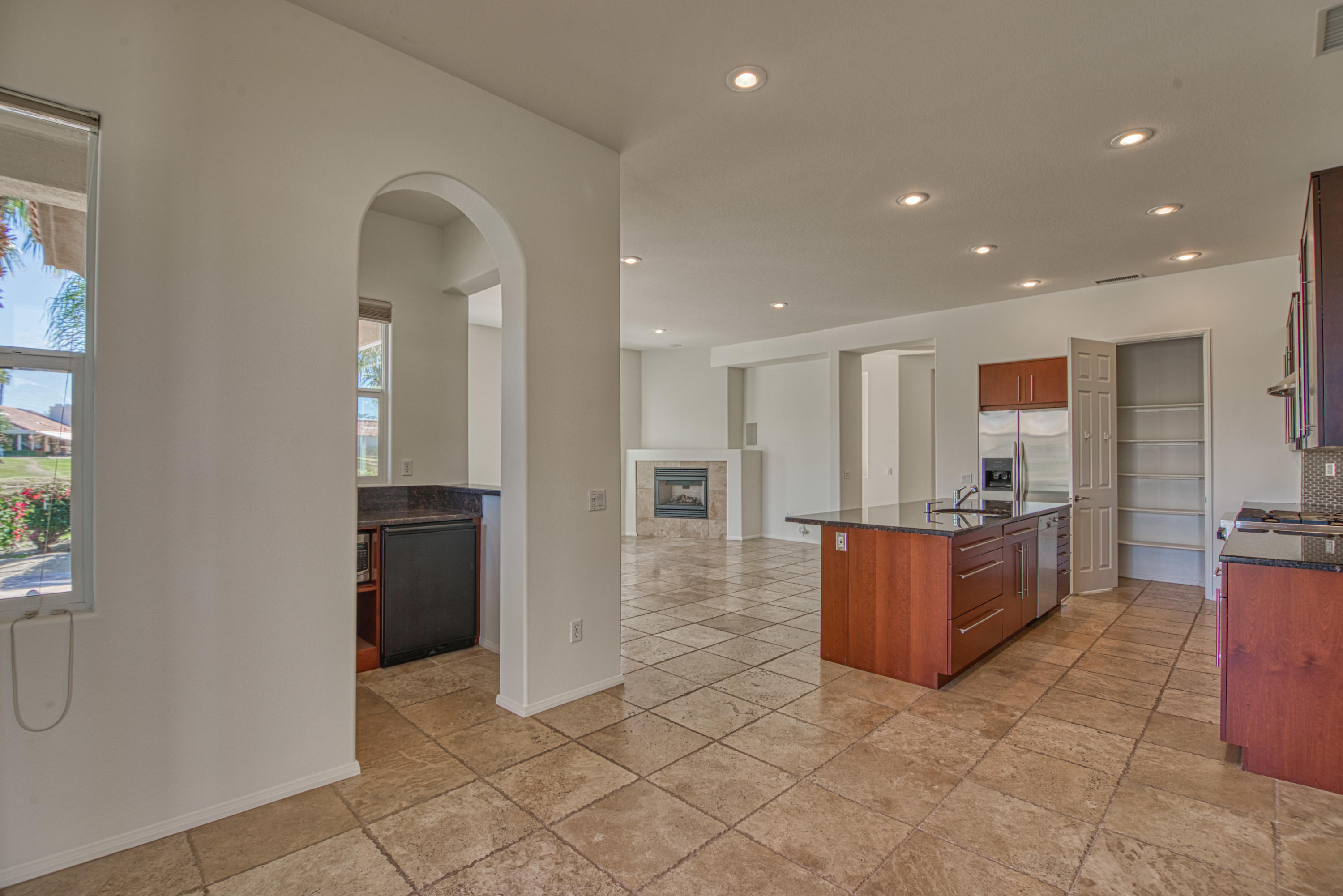 13 Wimbledon Circle Rancho Mirage, CA 92270 - Photo 57 of 62 a view of kitchen with kitchen island granite countertop a refrigerator and a sink