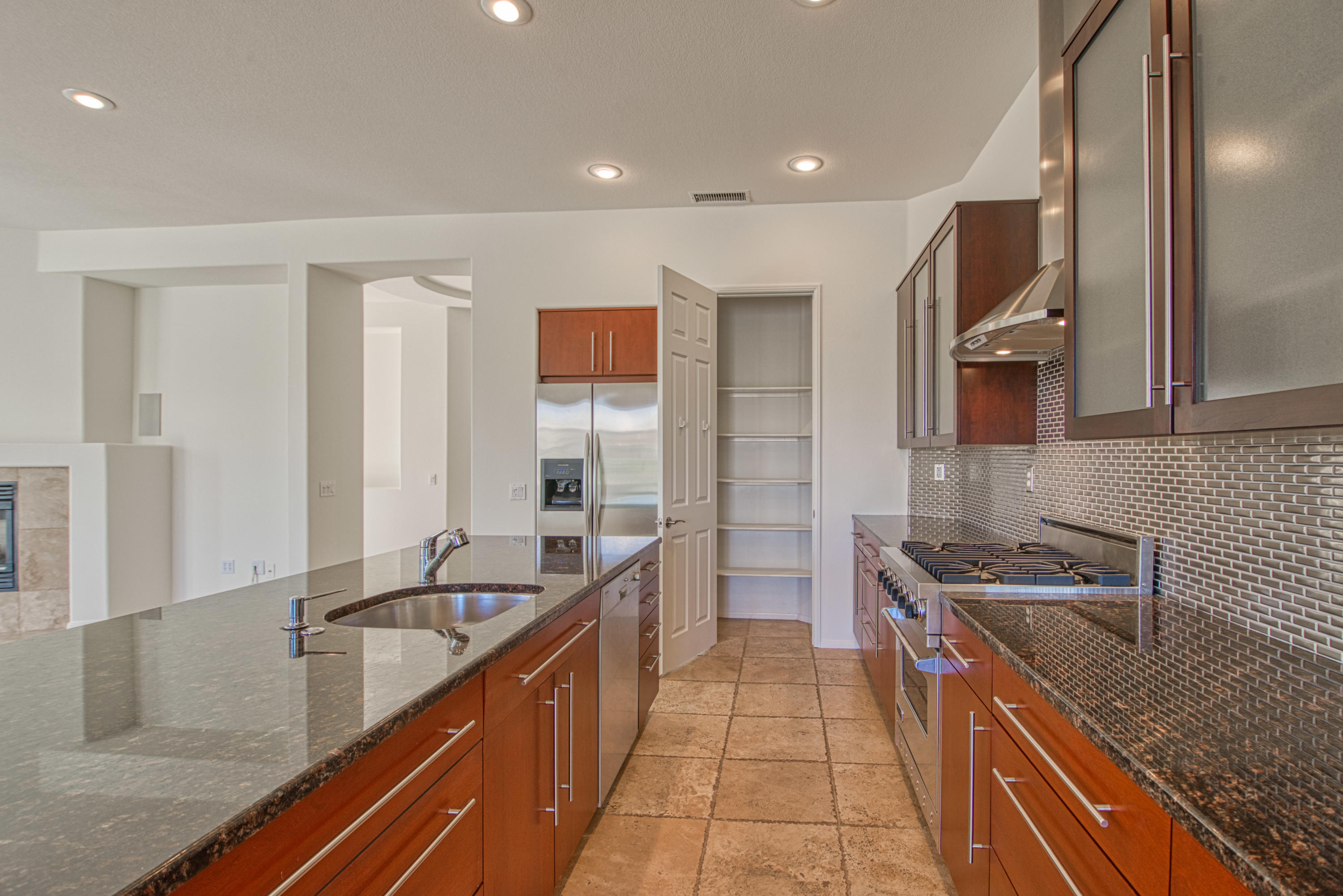13 Wimbledon Circle Rancho Mirage, CA 92270 - Photo 58 of 62 a kitchen with stainless steel appliances granite countertop a sink and a stove