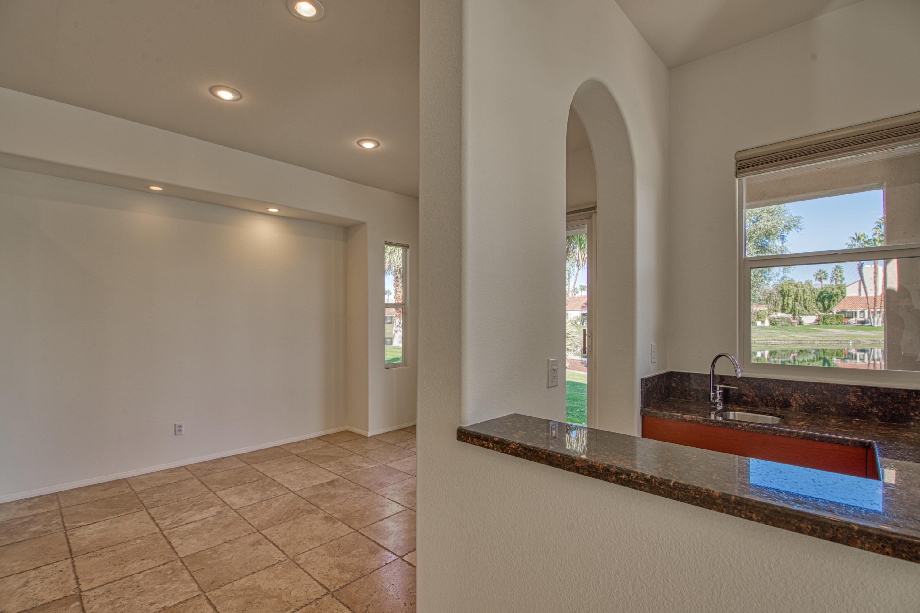 13 Wimbledon Circle Rancho Mirage, CA 92270 - Photo 59 of 62 a bathroom with a double vanity sink and a large mirror