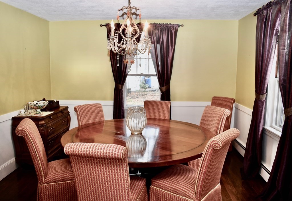 21 Jones Road Weston, MA 02493 - Photo 3 of 17 a view of a dining room with furniture a chandelier and wooden floor