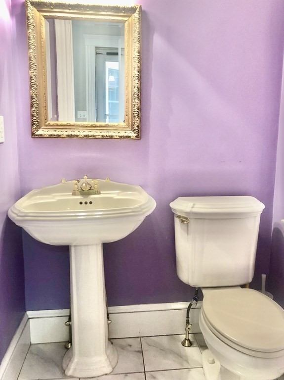 21 Jones Road Weston, MA 02493 - Photo 10 of 17 a white toilet sitting next to a bathroom sink