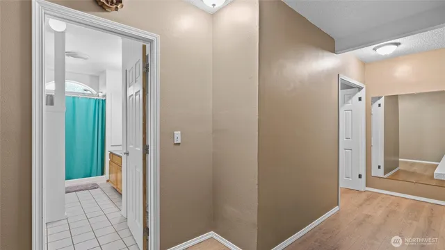a view of a hallway with wooden floor