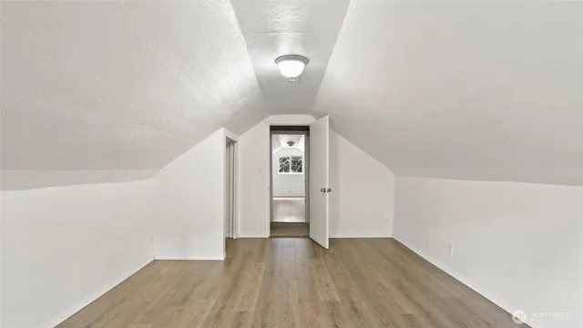 a view of a room with wooden floor and white walls