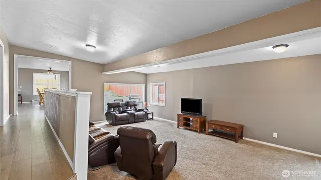 a view of a livingroom with furniture and a flat screen tv