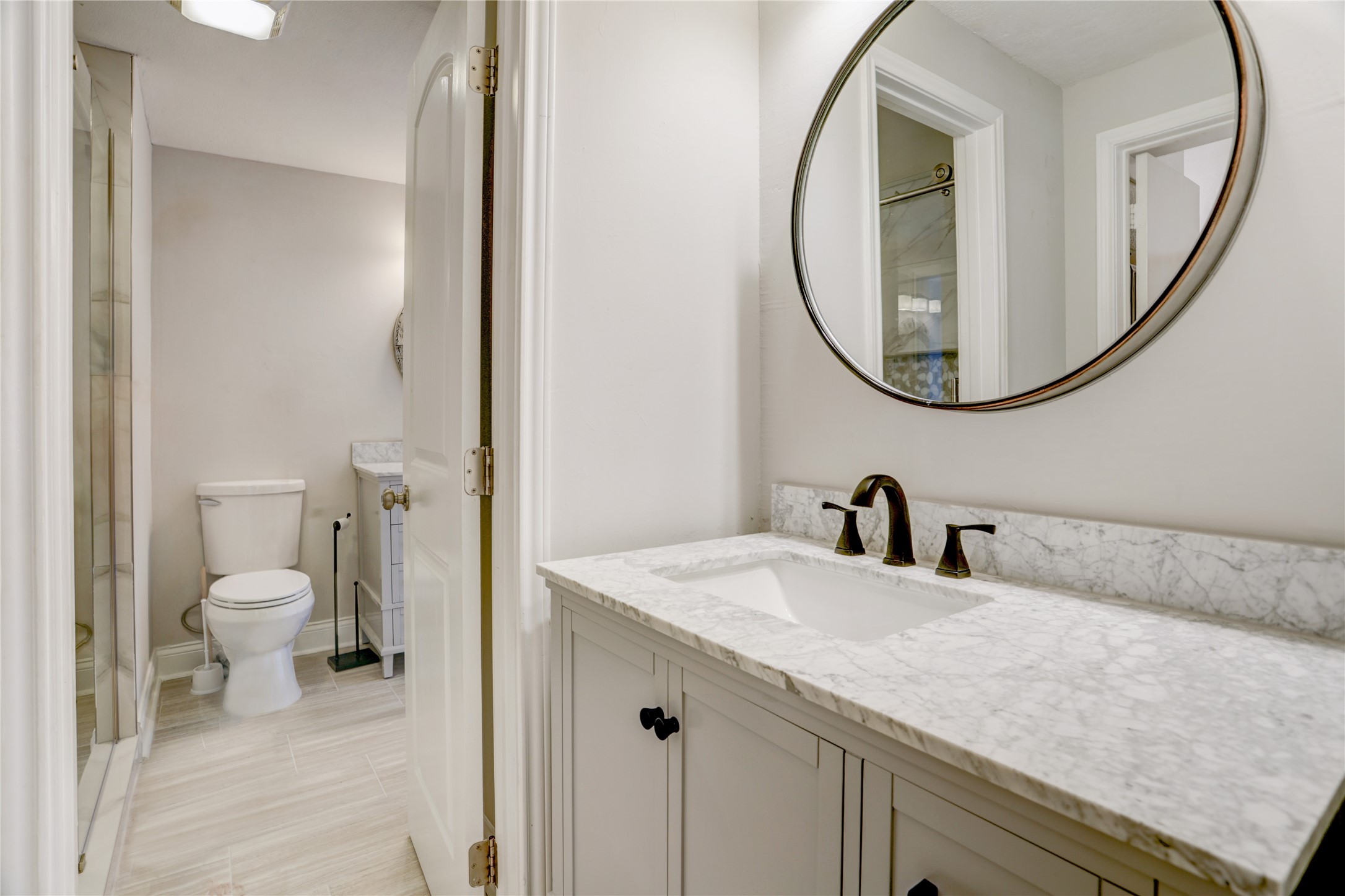 351 Lakeside Lane, Unit 102 Houston, TX 77058 - Photo 11 of 14 a bathroom with a granite countertop sink and a mirror
