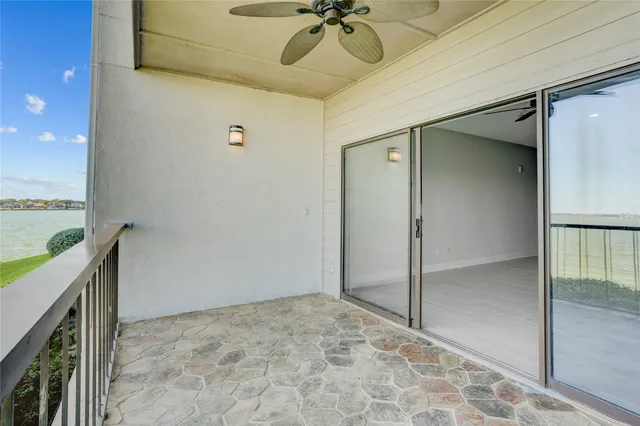 a white bed sitting in a room next to a window