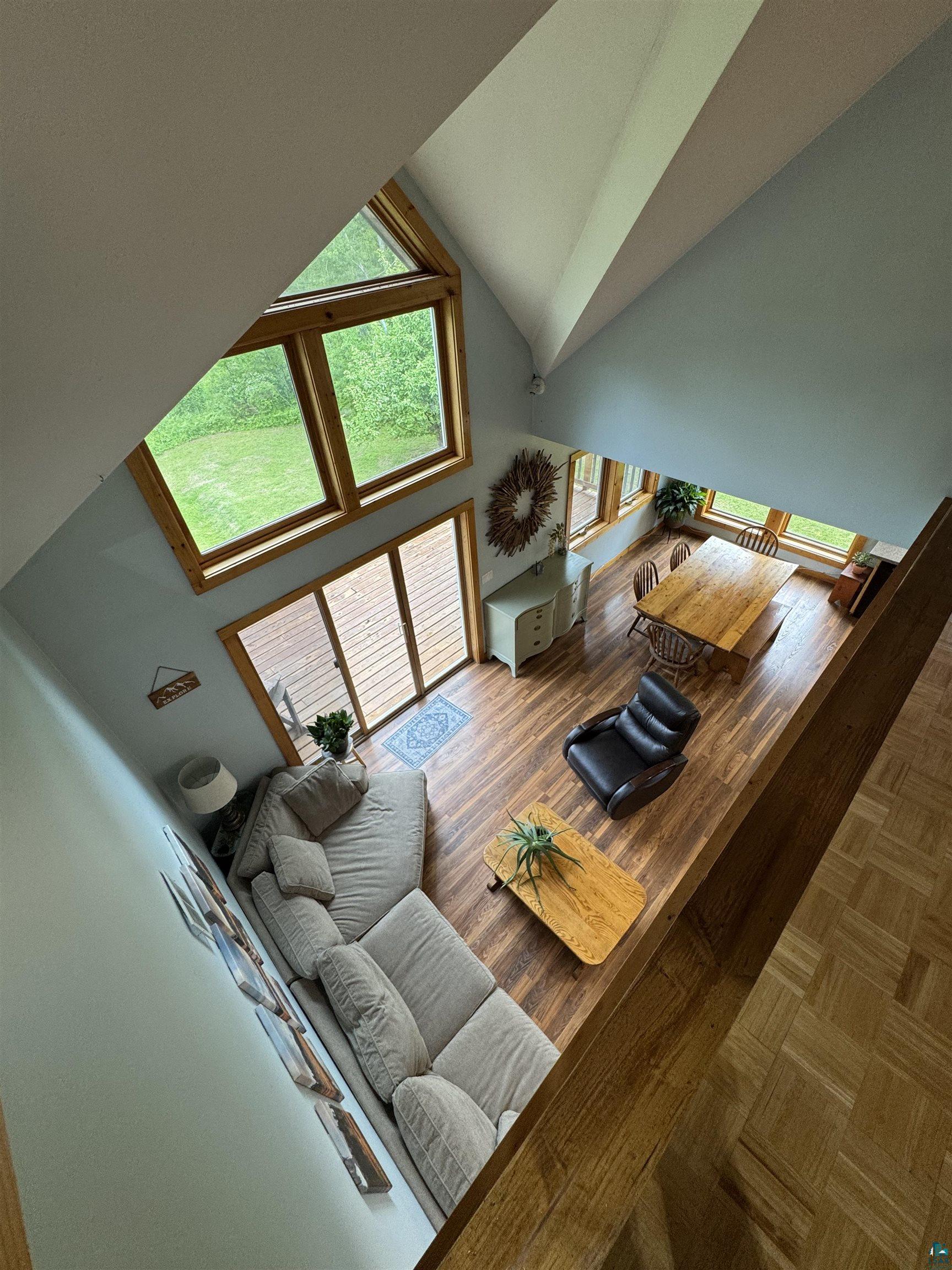 1745 Becks Road Maple, WI 54854 - Photo 28 of 46 View of living room from upper level. Vaulted ceiling great room with wood-finish flooring