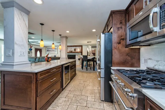 a kitchen with stainless steel appliances granite countertop a stove and a sink