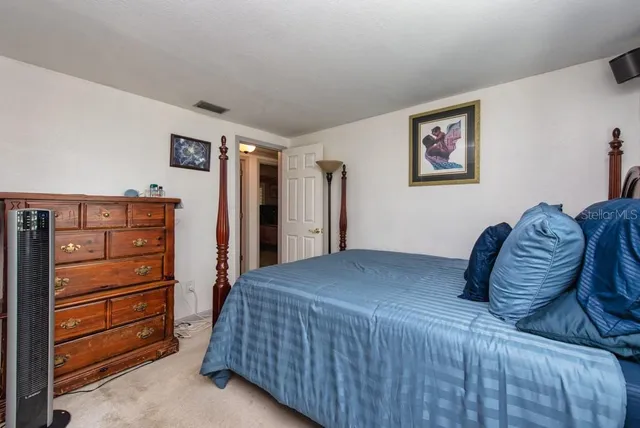 a bedroom with a bed and a dresser