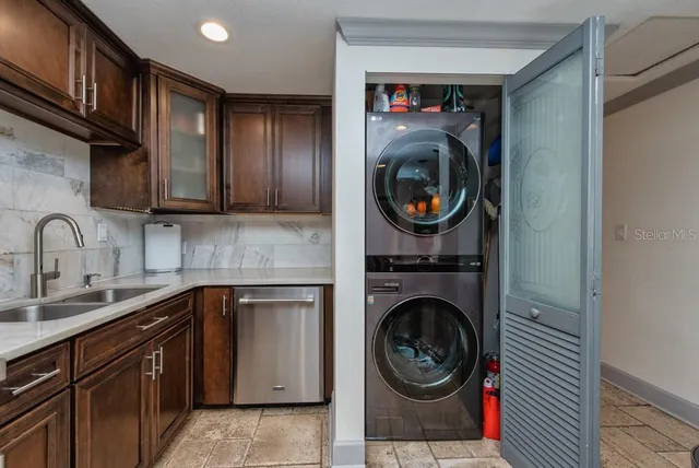 a utility room with sink dryer and washer