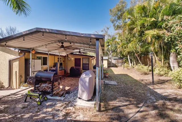 a view of a chairs and table in backyard