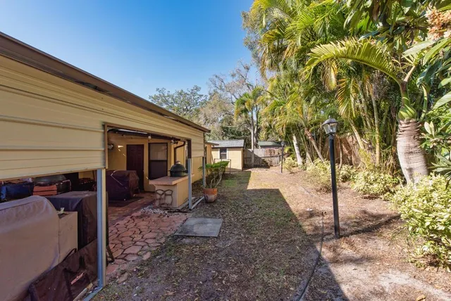 a view of a patio with table and chairs under an umbrella