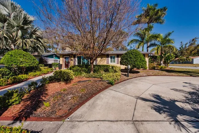 a front view of a house with a yard and a garage