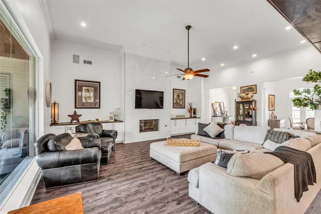 a living room with furniture a flat screen tv and a large window
