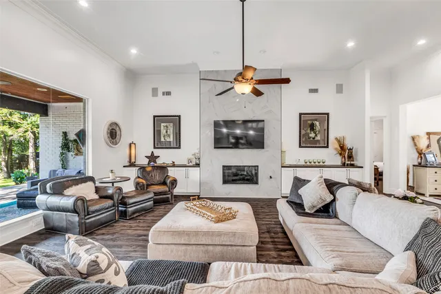 a living room with furniture kitchen view and a large window