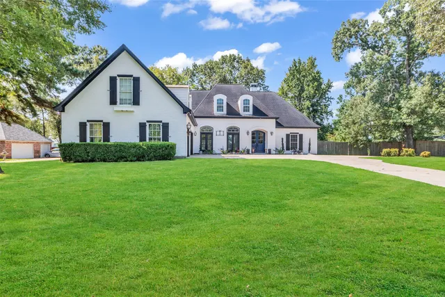 a front view of house with yard and green space