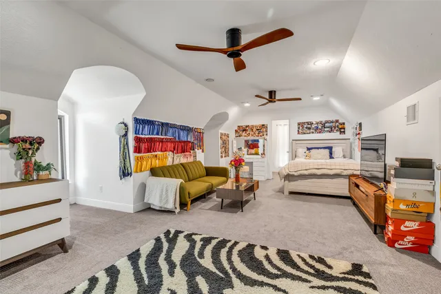 a bedroom with furniture and a ceiling fan