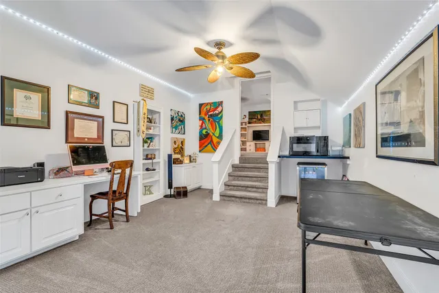 a view of a livingroom with furniture and staircase