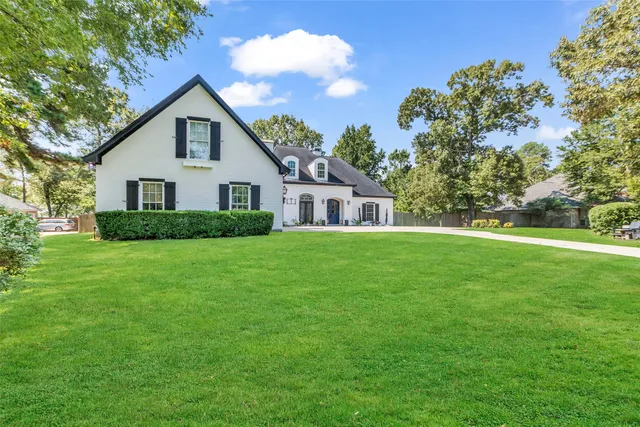a front view of house with yard and green space