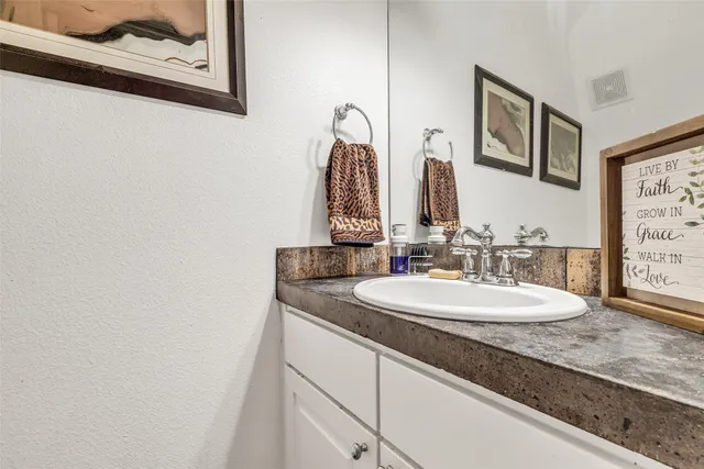 a bathroom with a double vanity sink and a mirror