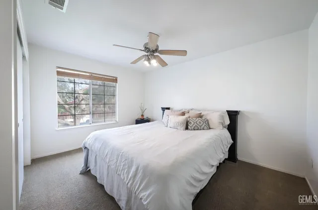 a bedroom with a bed and window