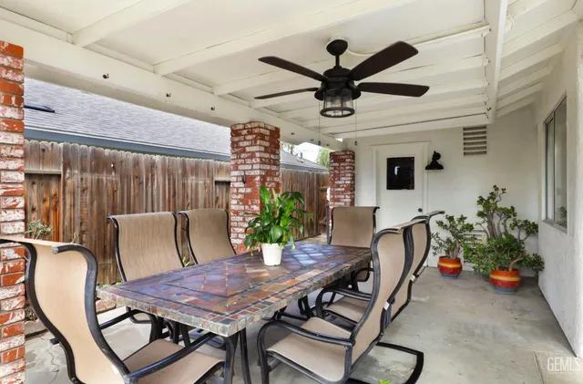 a view of a dining room with furniture and a ceiling fan