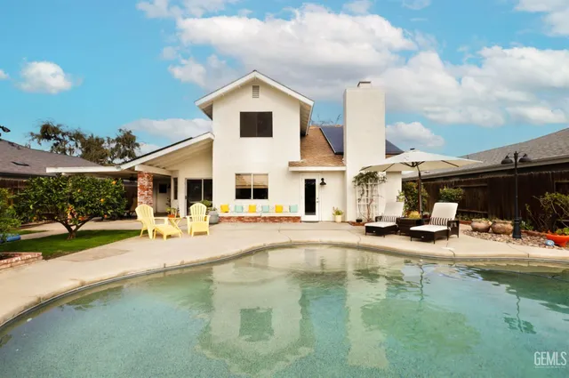 a swimming pool view with a outdoor seating