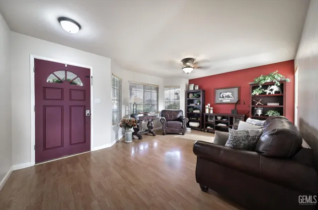 a living room with furniture flower pot and a wooden floor