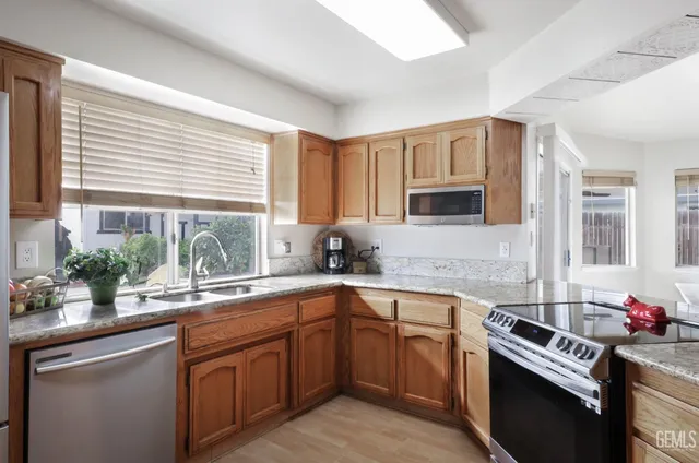 a kitchen with a sink stove top oven and microwave