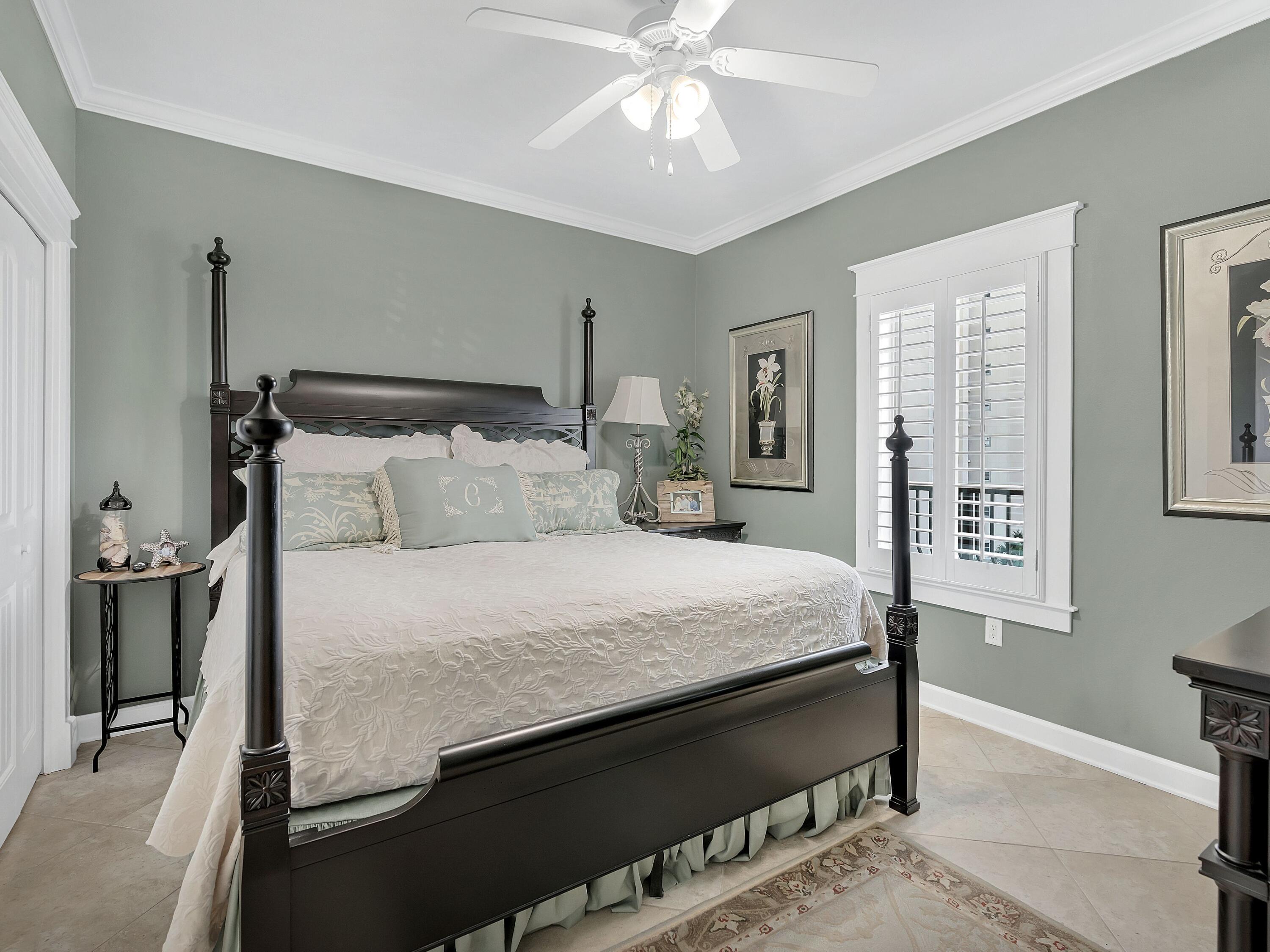 548 Sandy Cay Drive, Unit 510 Miramar Beach, FL 32550 - Photo 14 of 30 a bedroom with a bed and a chandelier