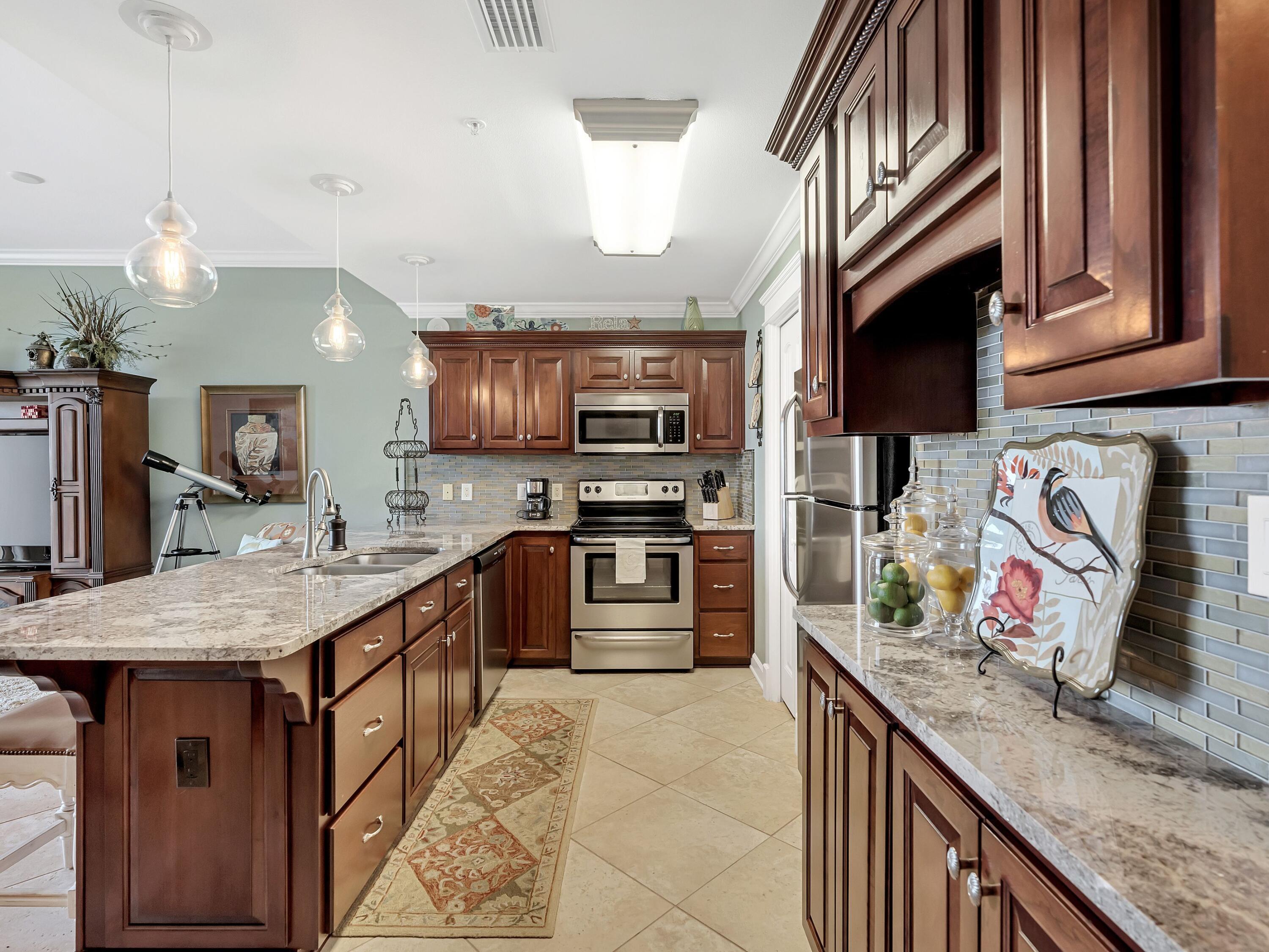 548 Sandy Cay Drive, Unit 510 Miramar Beach, FL 32550 - Photo 10 of 30 a kitchen with stainless steel appliances granite countertop a sink dishwasher stove and oven