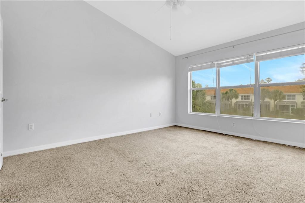 937 Hampton Circle, Unit 108 Naples, FL 34105 - Photo 16 of 32 an empty room with large windows