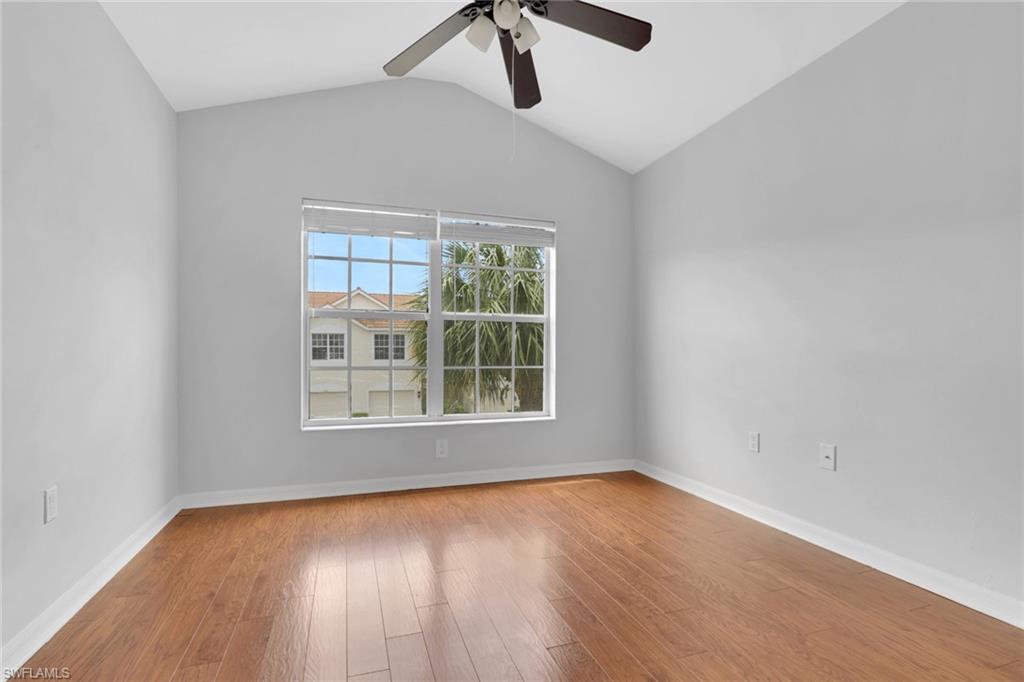 937 Hampton Circle, Unit 108 Naples, FL 34105 - Photo 18 of 32 wooden floor in an empty room with a window