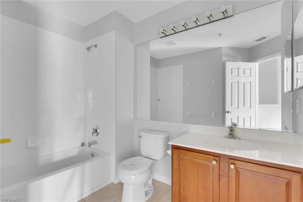 937 Hampton Circle, Unit 108 Naples, FL 34105 - Photo 21 of 32 a bathroom with a sink a toilet and a bathtub