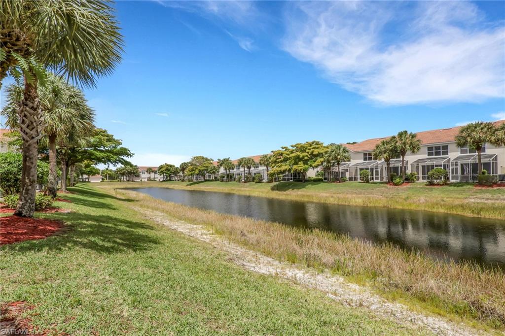 937 Hampton Circle, Unit 108 Naples, FL 34105 - Photo 26 of 32 a view of a lake with a houses