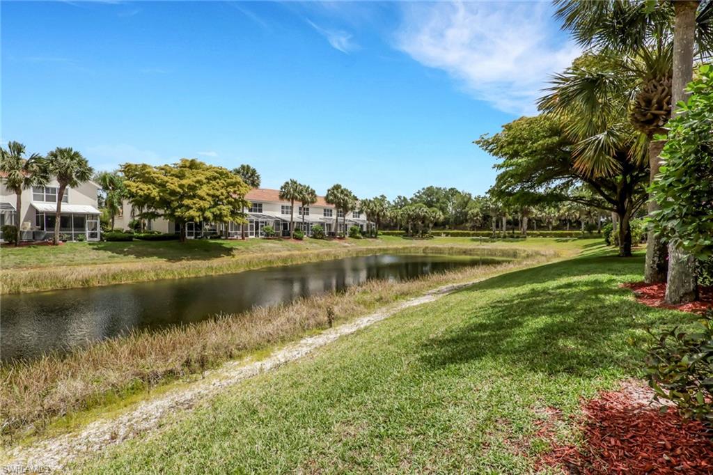 937 Hampton Circle, Unit 108 Naples, FL 34105 - Photo 27 of 32 a view of a lake with houses in the background