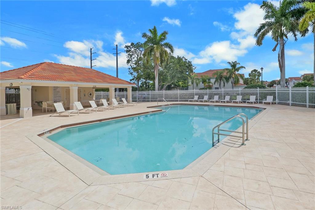 937 Hampton Circle, Unit 108 Naples, FL 34105 - Photo 30 of 32 a view of a swimming pool with lounge chair