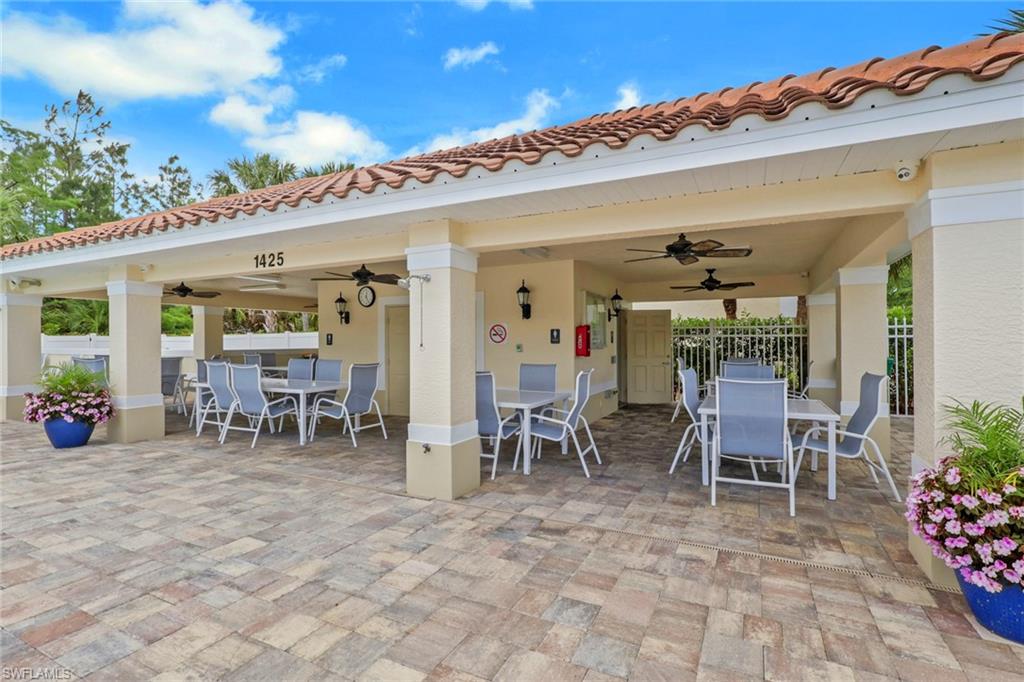 937 Hampton Circle, Unit 108 Naples, FL 34105 - Photo 31 of 32 a view of a dining room with furniture and chandelier