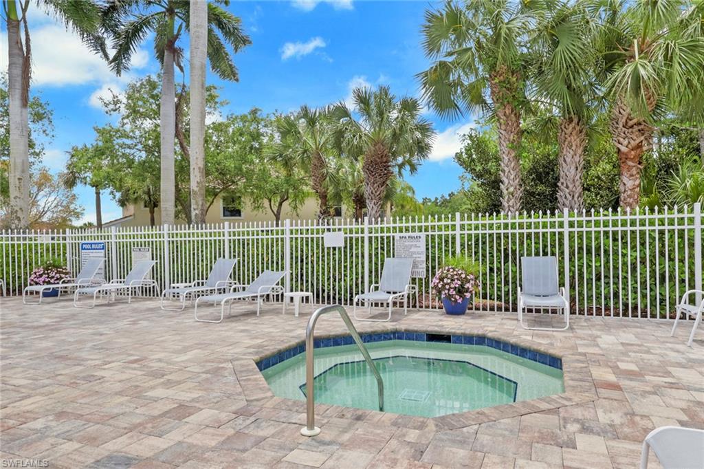 937 Hampton Circle, Unit 108 Naples, FL 34105 - Photo 32 of 32 a view of a swimming pool with a lounge chair