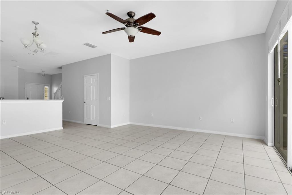 937 Hampton Circle, Unit 108 Naples, FL 34105 - Photo 8 of 32 a view of an empty room and chandelier fan