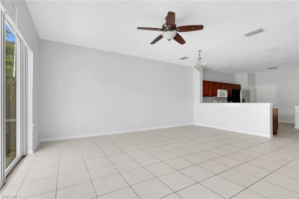 937 Hampton Circle, Unit 108 Naples, FL 34105 - Photo 10 of 32 a view of a livingroom with a ceiling fan and wooden floor