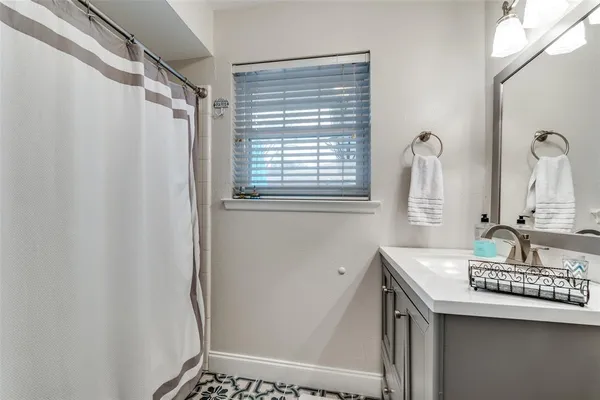 a bathroom with a sink a vanity and a shower
