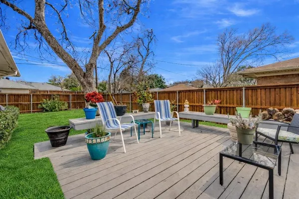a view of a chairs and tables in the back yard of the house