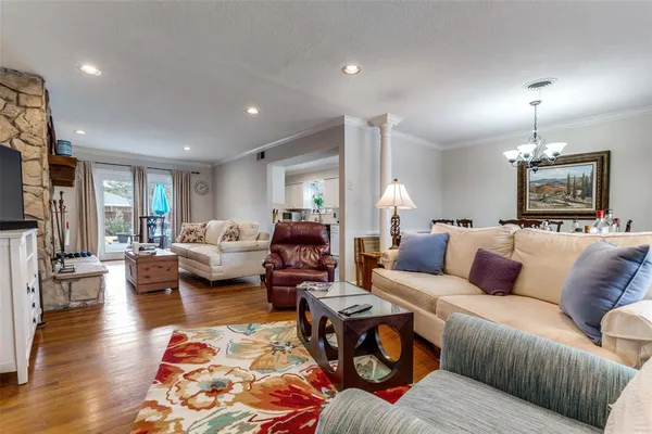 a living room with furniture fireplace and wooden floor