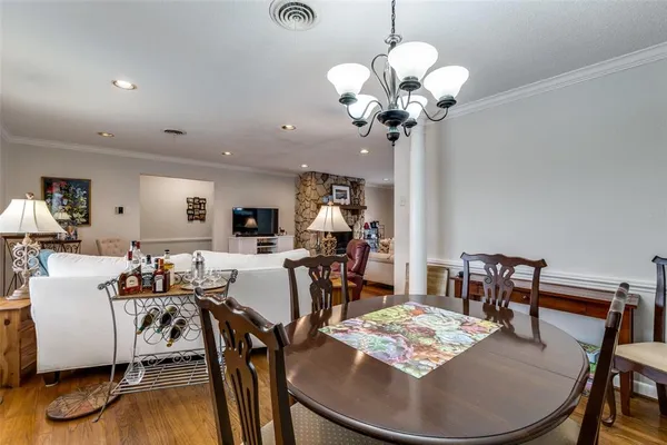a view of a dining room with furniture wooden floor and chandelier