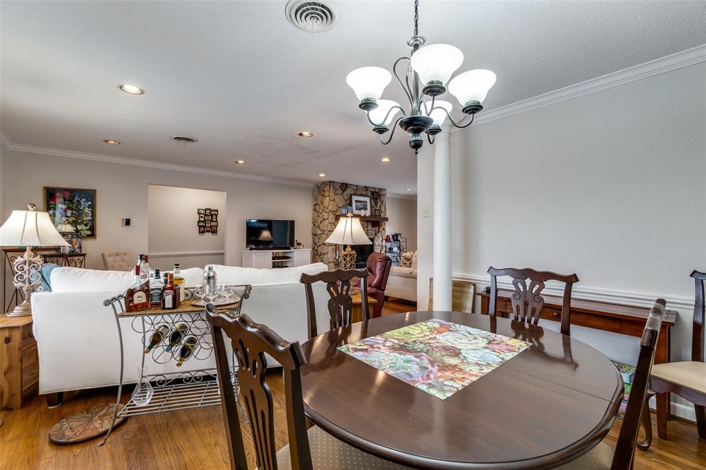 7144 Haverford Road Dallas, TX 75214 - Photo 5 of 14 a view of a dining room with furniture wooden floor and chandelier
