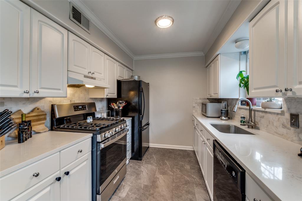 7144 Haverford Road Dallas, TX 75214 - Photo 6 of 14 a kitchen with stainless steel appliances granite countertop a sink stove and refrigerator
