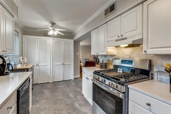 a kitchen with stainless steel appliances granite countertop a stove and a refrigerator