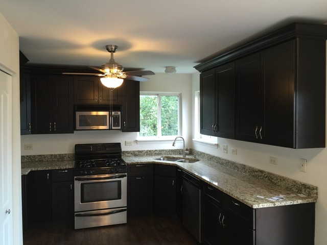 326 Prairie Ridge Drive Minooka, IL 60447 - Photo 3 of 16 a kitchen with granite countertop a stove and a sink